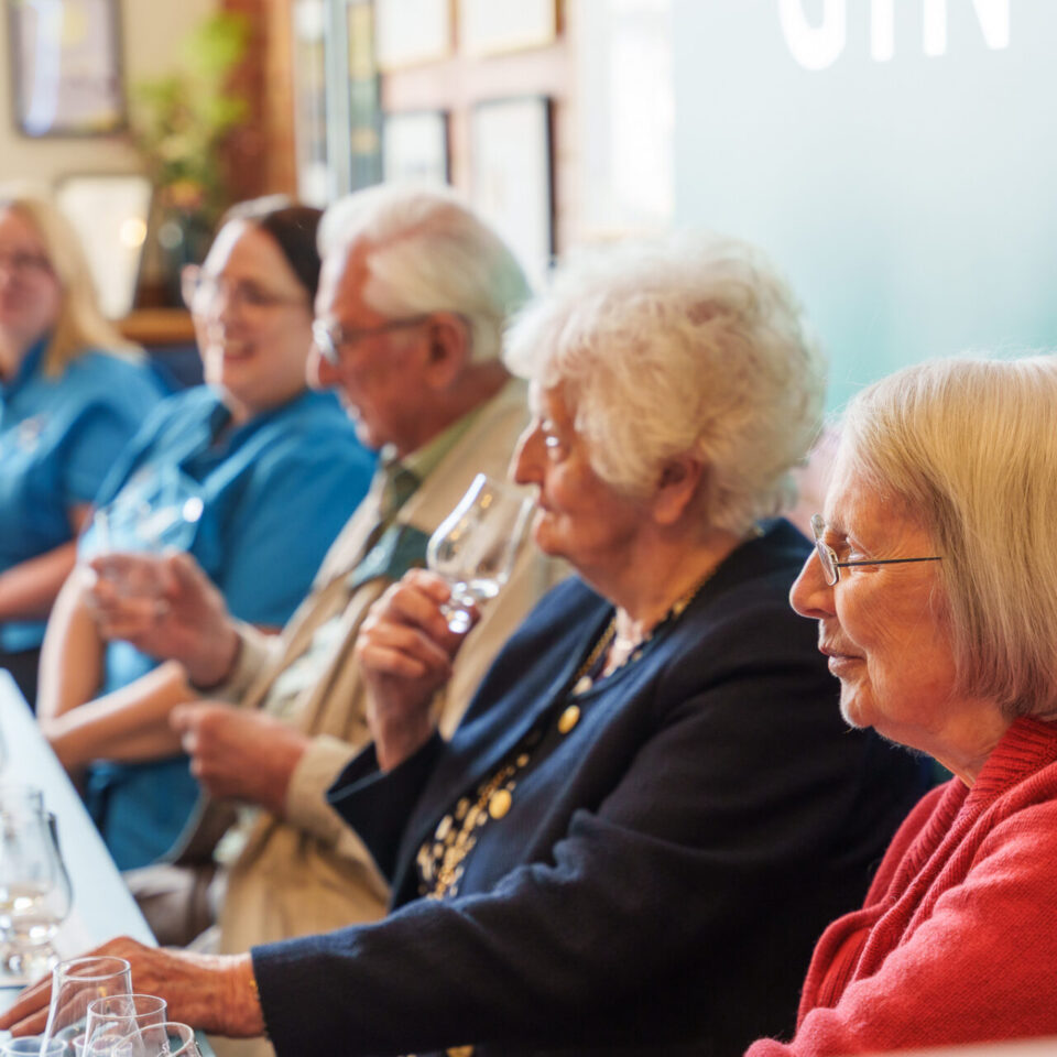 Residents and staff nosing and tasting gin at the Golden Hour launch