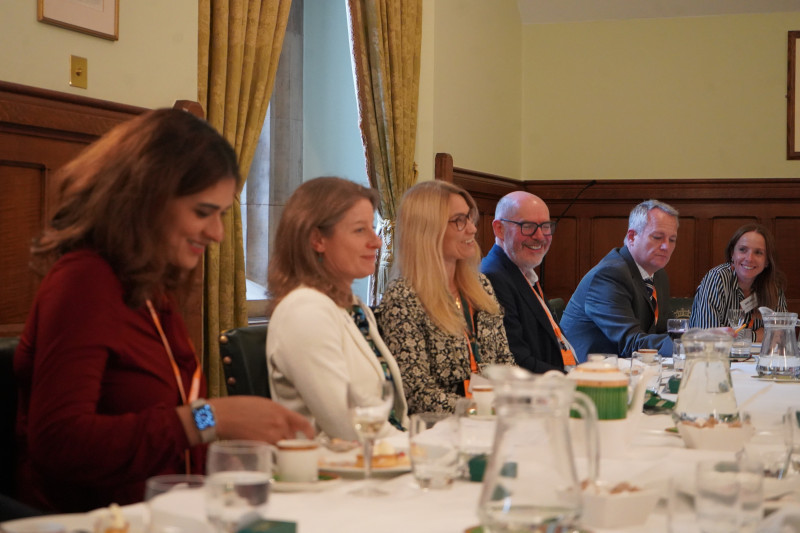 Delegates seated at the table by the window, in conversation